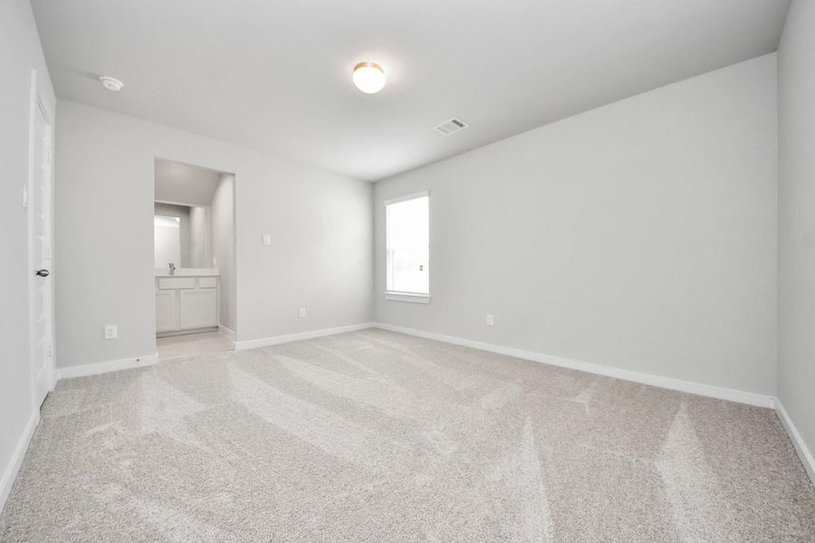 Secondary bedroom features plush carpeting, large windows that let in plenty of natural light, bright paint, and spacious closets. Sample photo of completed home with similar floor plan. Actual colors and selections may vary. Secondary bedroom features plush carpeting, large windows that let in plenty of natural light, bright paint, and spacious closets. Sample photo of completed home with similar floor plan. Actual colors and selections may vary.