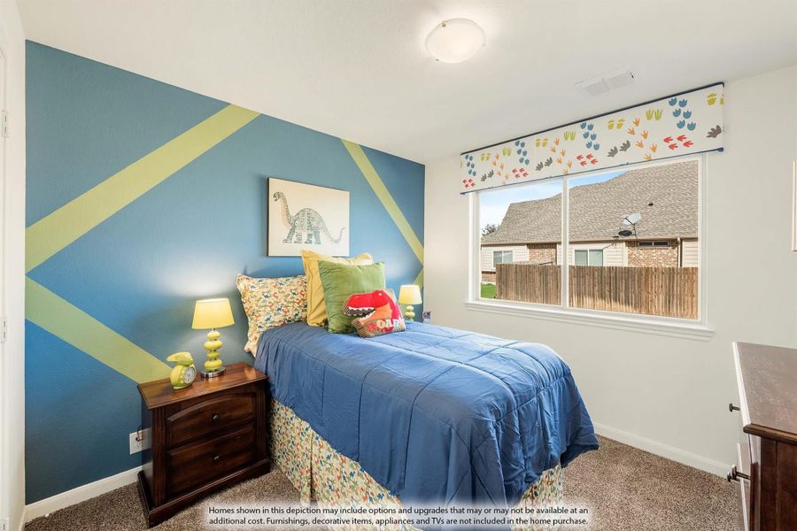 Children's bedroom with blue geometric accent wall, twin bed, and dinosaur-themed decor