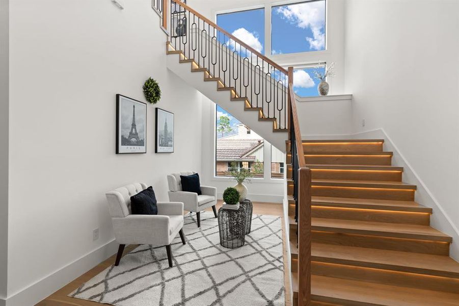 Stunning Staircase with secluded seating area and wall of windows!