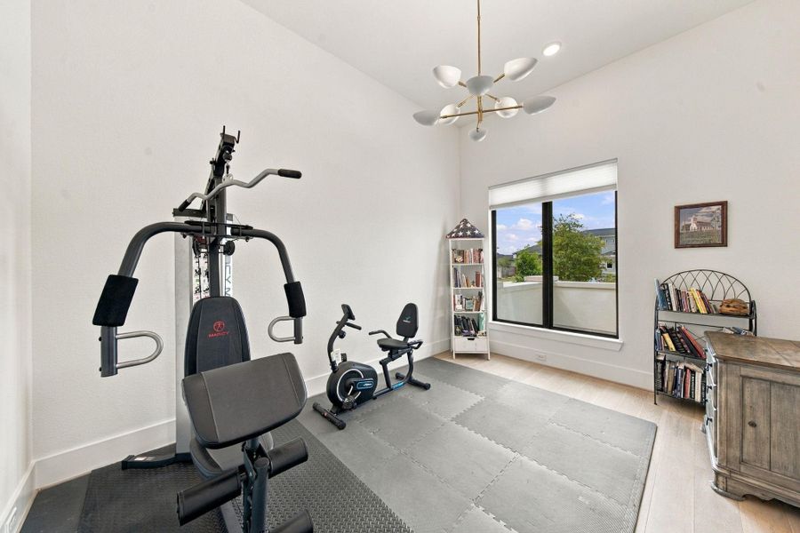 Designed with flexibility in mind, this room works beautifully as a home office or, as staged here, a private workout space.