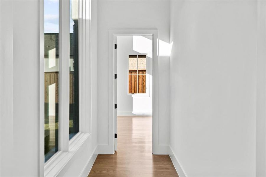 Hallway with wood finished floors and baseboards Hallway with wood finished floors and baseboards