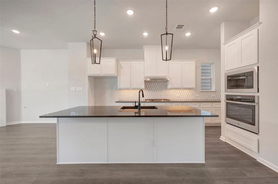 Kitchen island featuring a black countertop and integrated sink Kitchen island featuring a black countertop and integrated sink
