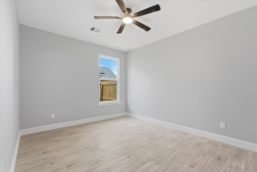 Bright and versatile secondary bedroom featuring a soft neutral color palette. Perfectly sized for a guest room, home office, or nursery, this space maintains a clean, modern aesthetic that is completely move-in ready.