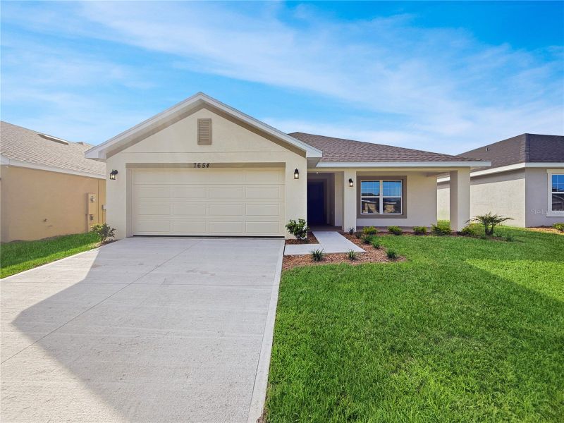 Front exterior of a new home in Harmony Central, St. Cloud, FL, highlighting curb appeal (Image 1). Front exterior of a new home in Harmony Central, St. Cloud, FL, highlighting curb appeal (Image 1).