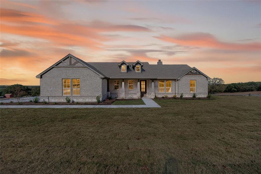 View of front of house with a lawn, covered porch, a chimney, and brick siding View of front of house with a lawn, covered porch, a chimney, and brick siding