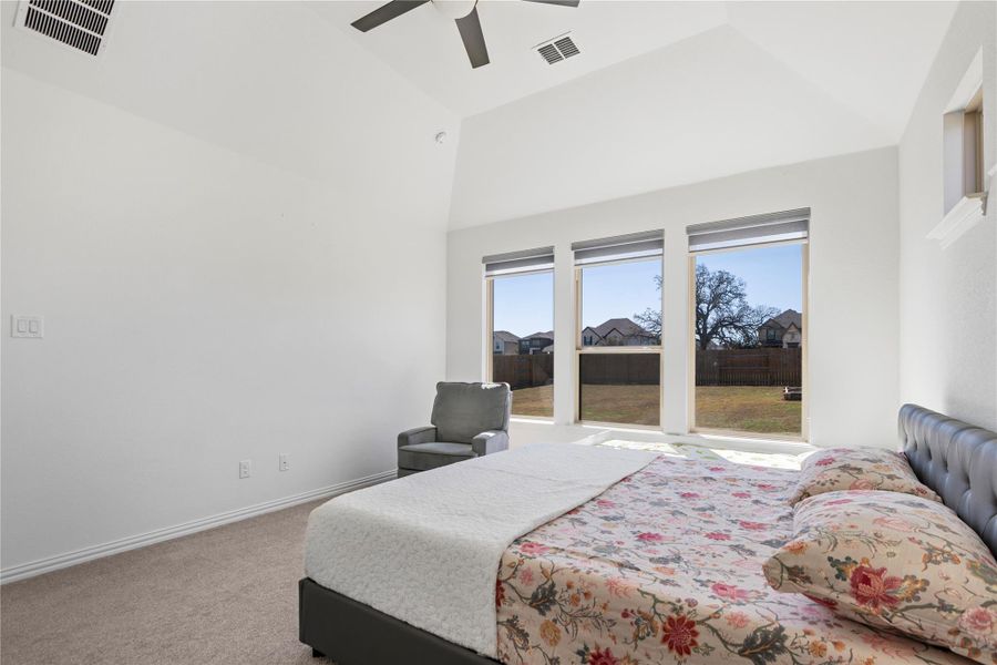 A spacious sleeping area with vaulted ceilings and outdoor views offers a peaceful retreat. A spacious sleeping area with vaulted ceilings and outdoor views offers a peaceful retreat.
