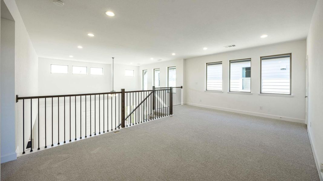 Carpeted spare room featuring recessed lighting and baseboards