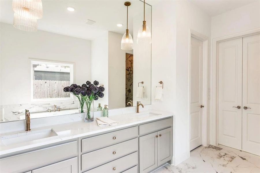 Full bath with double vanity, light marble finish flooring, recessed lighting, curtained shower, and a closet