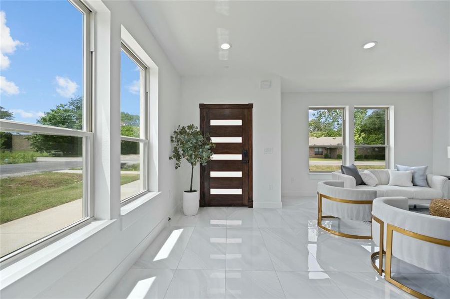 Entryway with recessed lighting, baseboards, and light tile patterned floors