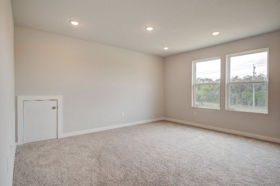 A room with a carpet and windows. A room with a carpet and windows.