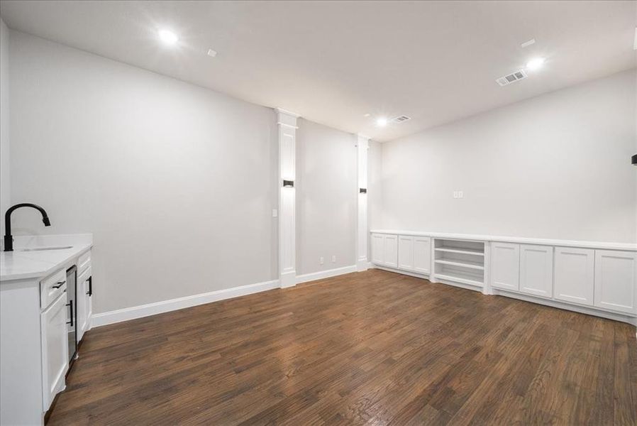 Unfurnished room featuring sink and dark hardwood / wood-style flooring