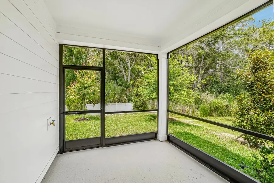 Spacious screened in back lanai with a tranquil and lush tree surrounding Spacious screened in back lanai with a tranquil and lush tree surrounding