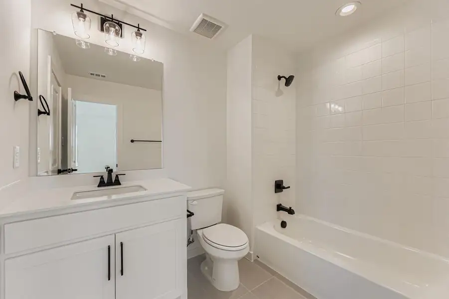 Full bath featuring light tile patterned flooring, shower / tub combination, vanity, and recessed lighting