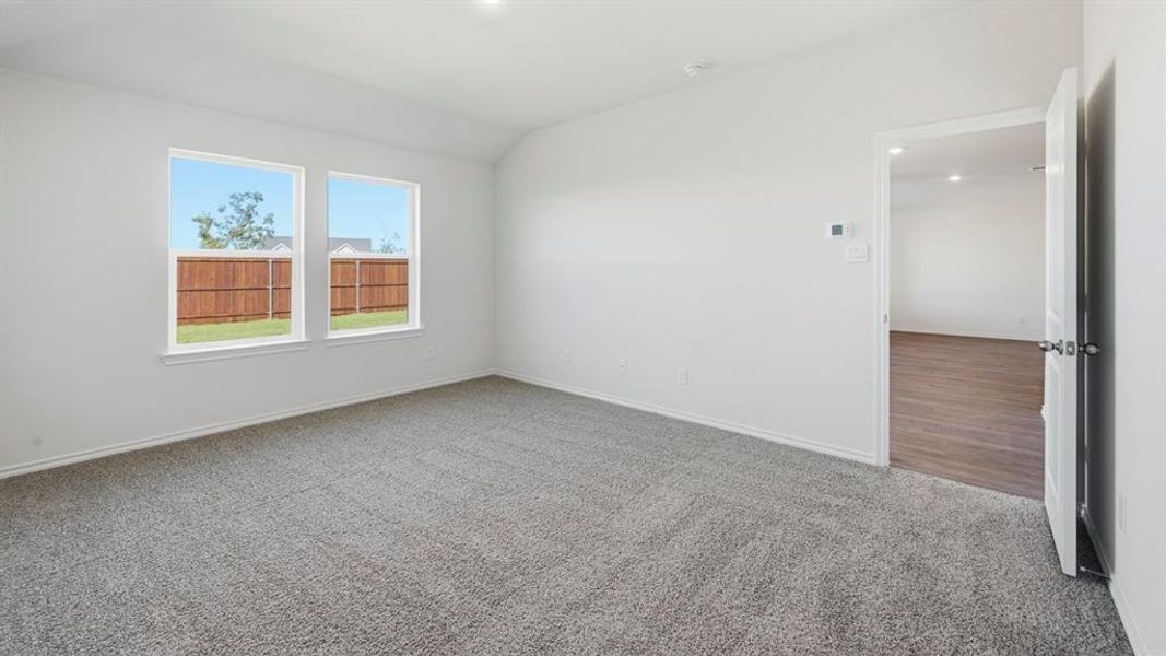 Unfurnished room featuring light colored carpet, vaulted ceiling, and recessed lighting