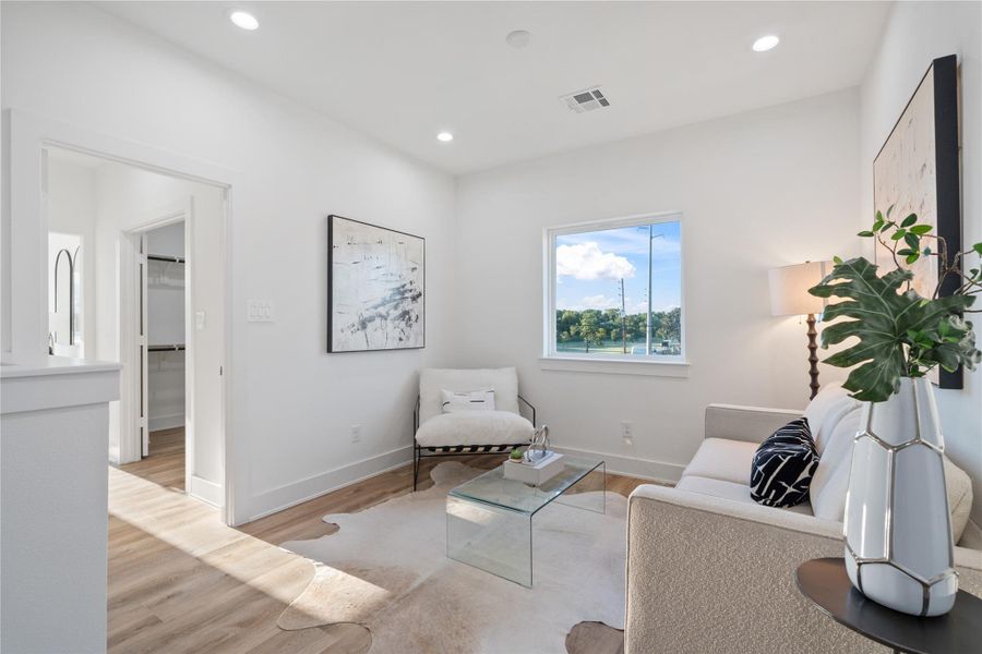 This upstairs flexible space creates the perfect separation between the primary suite and secondary bedrooms. It offers privacy while still maintaining connectivity within the home. The design enhances both comfort and functionality for family living.