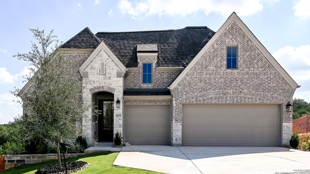 Front exterior of a new home in Johnson Ranch 55', Bulverde, TX, highlighting curb appeal (Image 17). Front exterior of a new home in Johnson Ranch 55', Bulverde, TX, highlighting curb appeal (Image 17).
