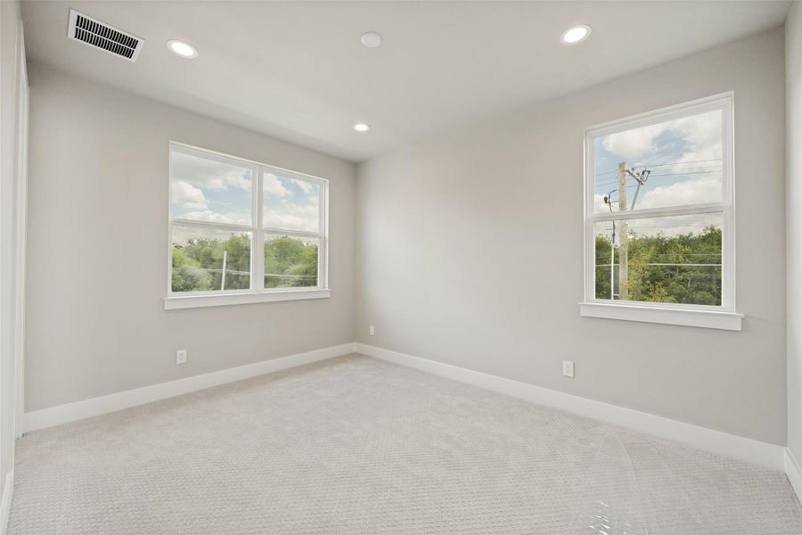 Recessed lighting and ample windows illuminate this comfortable, well-proportioned bedroom space. Recessed lighting and ample windows illuminate this comfortable, well-proportioned bedroom space.