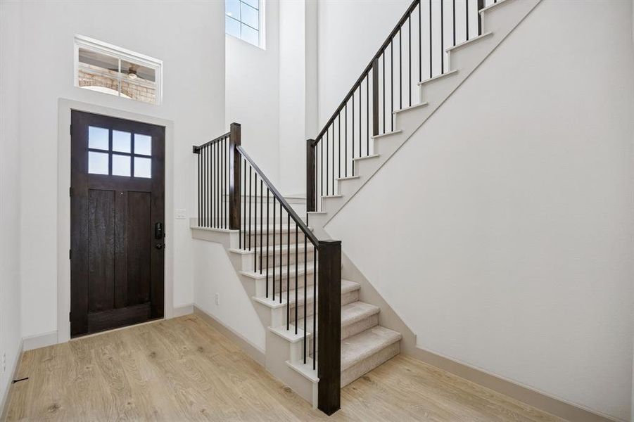 With a stunning open railing stair case, this gorgeous entry area is the perfect place to welcome family and friends! With a stunning open railing stair case, this gorgeous entry area is the perfect place to welcome family and friends!