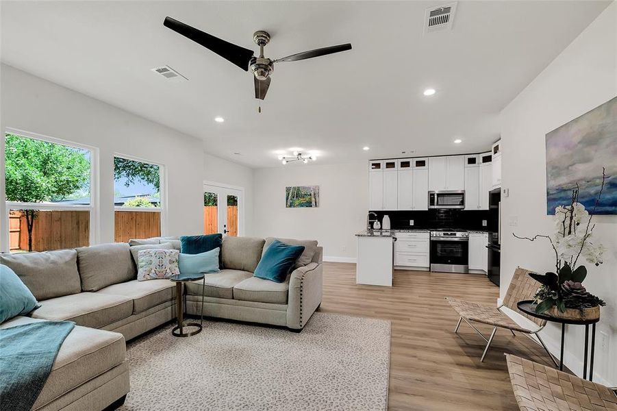 Living room featuring ceiling fan and wood-style flooring