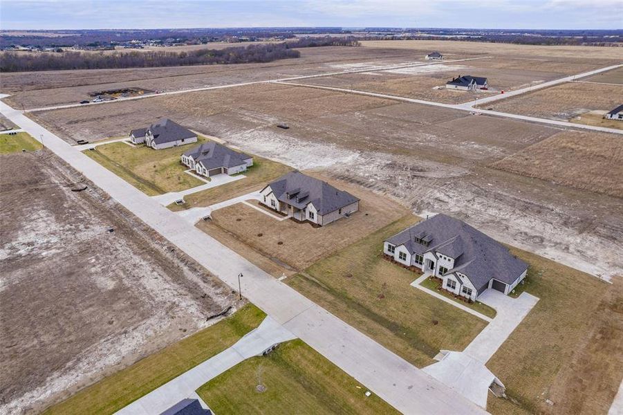 Front exterior of a new home in , Waxahachie, TX, highlighting curb appeal (Image 7).