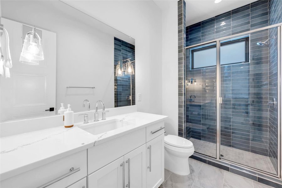 Bathroom three: Clean lines and modern tile work define this contemporary bathroom space.