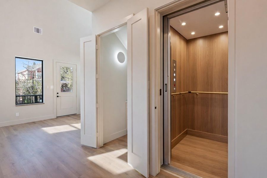 Existing elevator shaft can stop at all 3 levels (Elevator virtually staged)