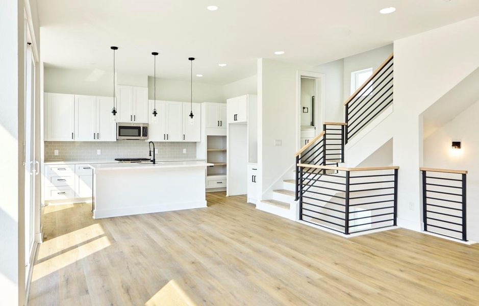 Bright and spacious, this open-concept living, dining, and kitchen area is perfect for entertaining. Featuring pristine quartz countertops, stainless steel appliances, and custom cabinetry, it’s a chef’s dream with plenty of space for hosting guests or enjoying family meals. Bright and spacious, this open-concept living, dining, and kitchen area is perfect for entertaining. Featuring pristine quartz countertops, stainless steel appliances, and custom cabinetry, it’s a chef’s dream with plenty of space for hosting guests or enjoying family meals.