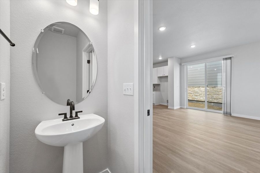 A bathroom with a large mirror.