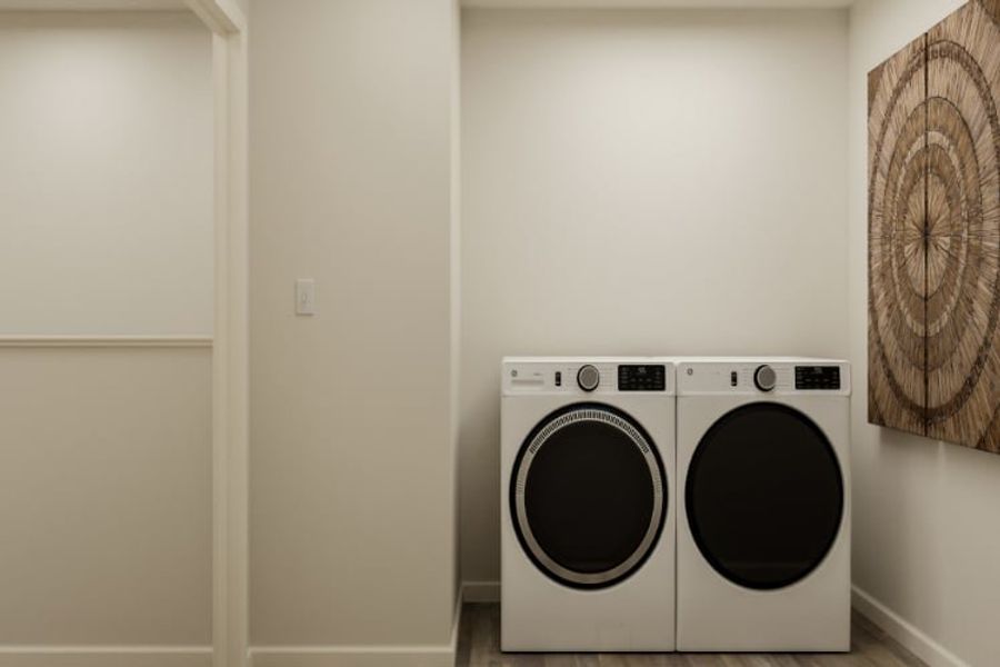 A white wall with a washing machine and a white door.
