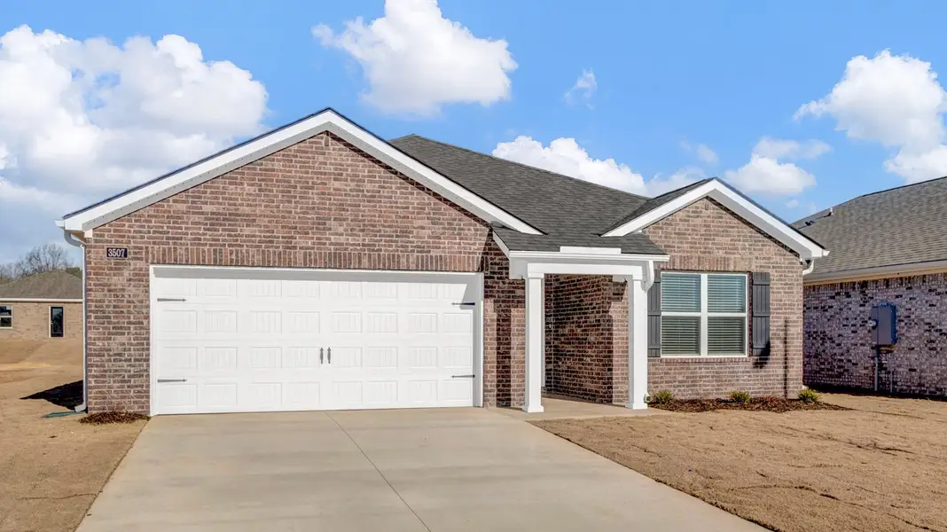 Front exterior of a new home in Riggs Pointe, Millington, TN, highlighting curb appeal (Image 2).