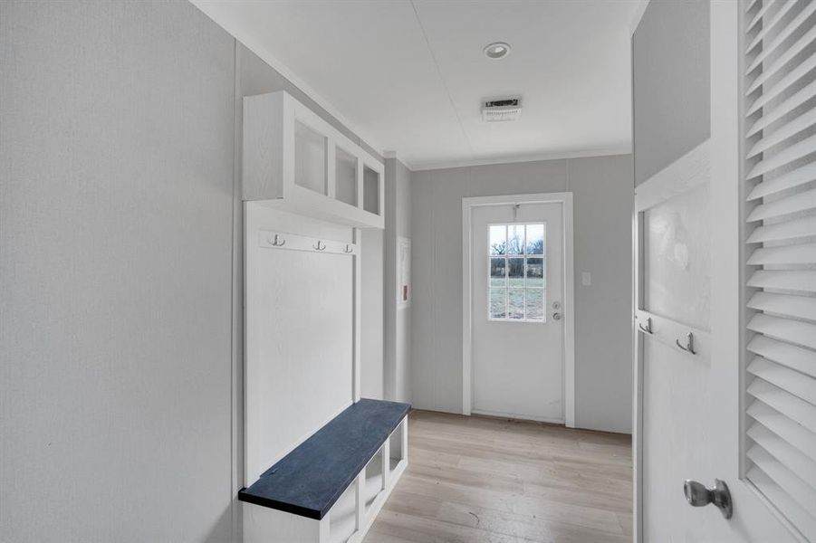 Mudroom featuring light wood-style floors