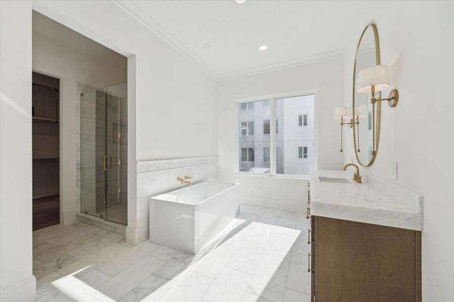 Custom Benedettini cabinetry, Bianco Superiore Quartzite countertops, Kallista Perfect under-mount centricrectangle sinks with Kallista One fixtures, weathered brass sconces complete this elegant and serene primary retreat.