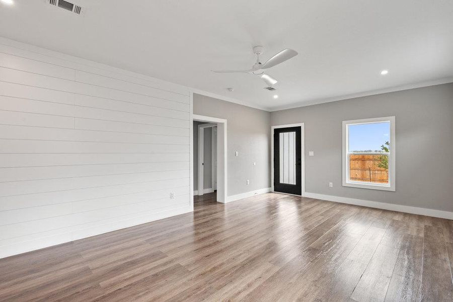 Unfurnished room with recessed lighting, wood finished floors, ornamental molding, and a ceiling fan