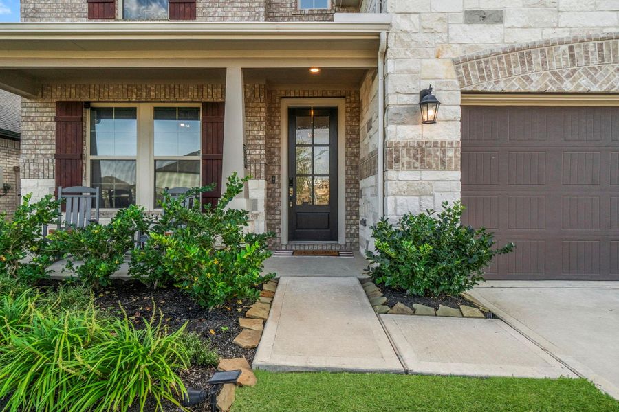 Welcome home! Beautiful brick & stone exterior and very well maintained flower beds greet you.