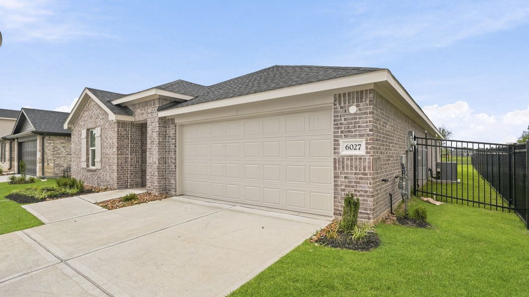 Front exterior of a new home in Sunterra, Katy, TX, highlighting curb appeal (Image 22).
