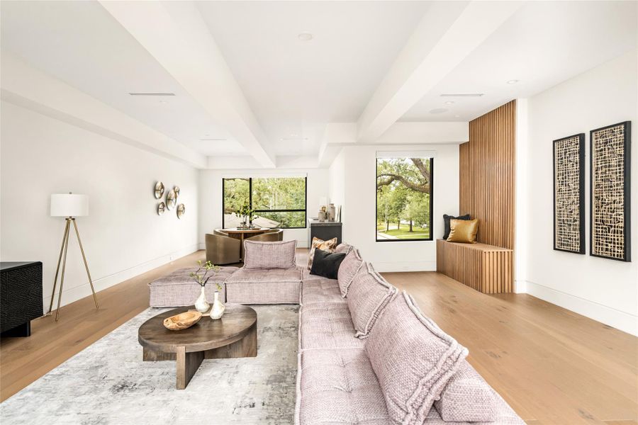 Expansive upstairs living space offering a versatile layout, abundant natural light, and custom wood detailing.