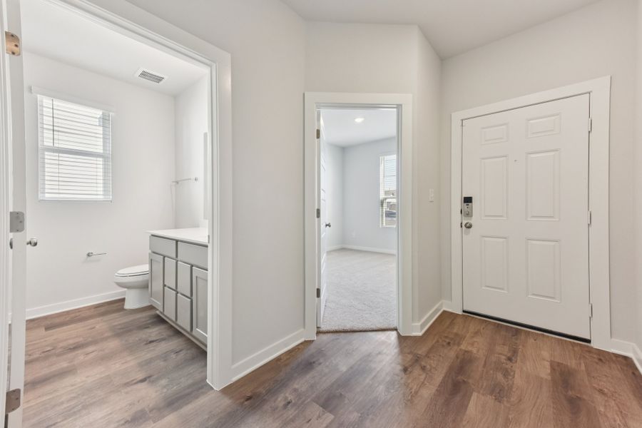 A bathroom with white cabinets. A bathroom with white cabinets.