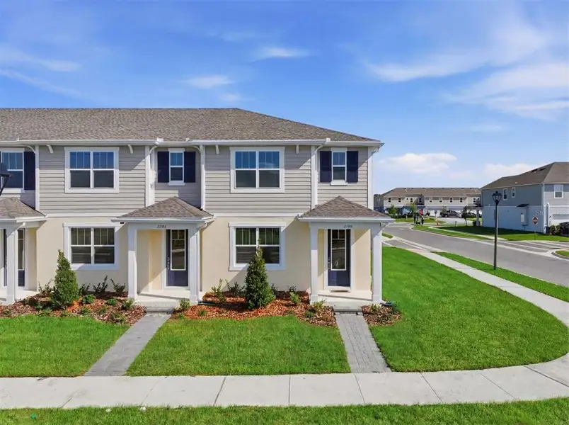 Front exterior of a new home in Gardenia Reserve, Apopka, FL, highlighting curb appeal (Image 2). Front exterior of a new home in Gardenia Reserve, Apopka, FL, highlighting curb appeal (Image 2).
