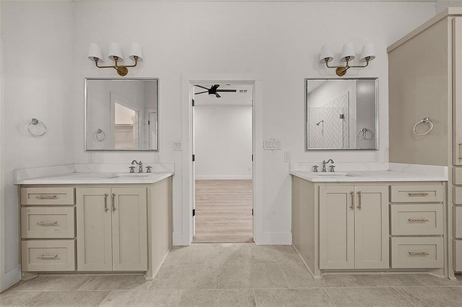 Bathroom with a stall shower, two vanities, and light tile patterned floors Bathroom with a stall shower, two vanities, and light tile patterned floors