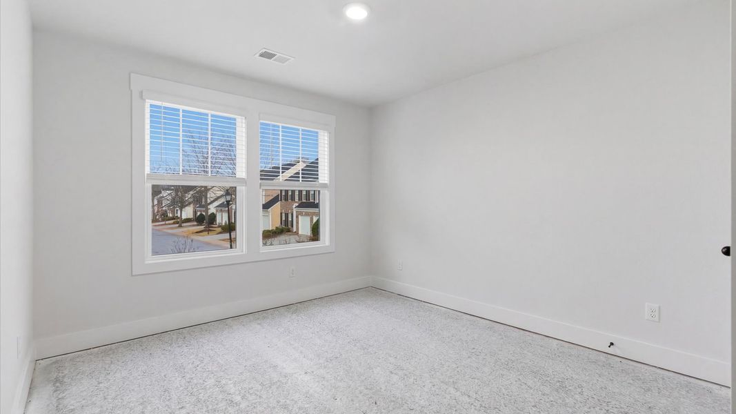 First-rate bedroom with plush carpeting and large windows that provide an open, airy feel located in Greenville, SC