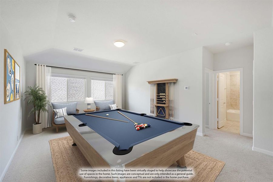 Game room with pool table, vaulted ceiling, carpet flooring, and adjacent bathroom visible through open door.