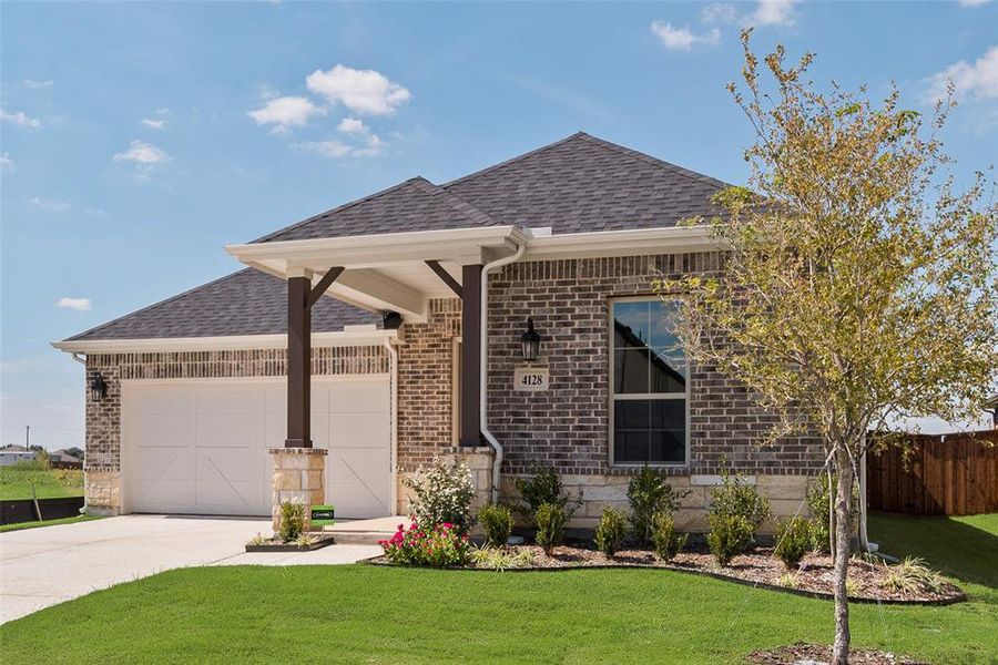 Front exterior of a new home in Spiritas Ranch, Little Elm, TX, highlighting curb appeal (Image 2). Front exterior of a new home in Spiritas Ranch, Little Elm, TX, highlighting curb appeal (Image 2).