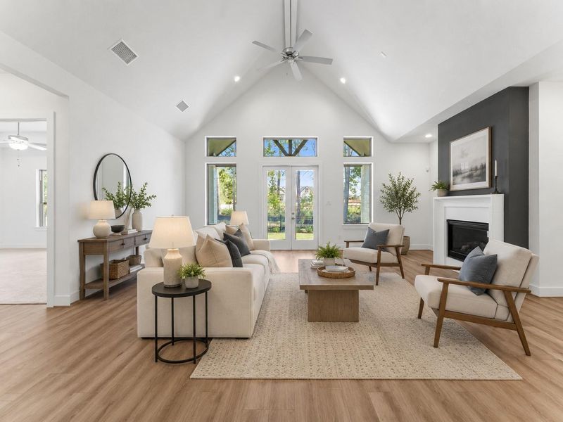 Spacious great room with cathedral ceiling, gas log fireplace, and double doors to the covered patio. VIRTUALLY STAGED Spacious great room with cathedral ceiling, gas log fireplace, and double doors to the covered patio. VIRTUALLY STAGED