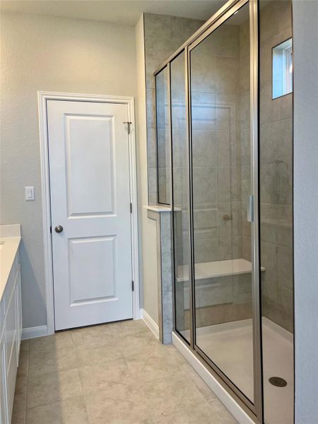 Full bath featuring a shower stall and vanity