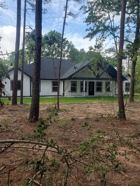 FRONT OF HOME AS SEEN FROM THE FRONT YARD WITH TALL MATURE TREES FRONT OF HOME AS SEEN FROM THE FRONT YARD WITH TALL MATURE TREES