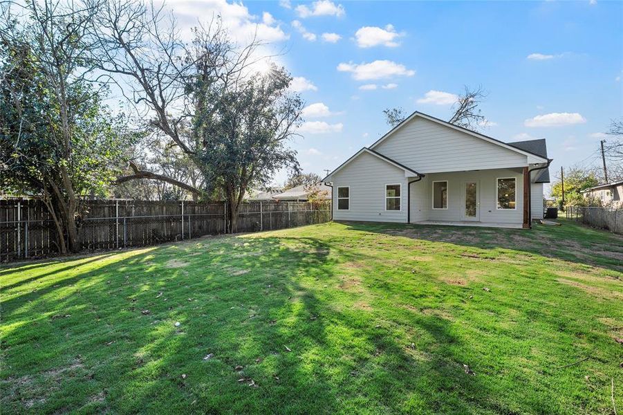 Rear view of house featuring a patio area and a fenced backyard Rear view of house featuring a patio area and a fenced backyard