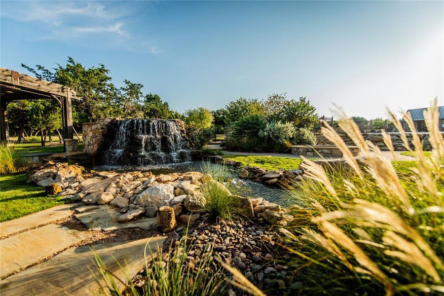View of home's community with a garden pond View of home's community with a garden pond