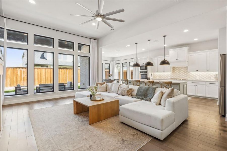 Living room featuring light wood-type flooring and ceiling fan