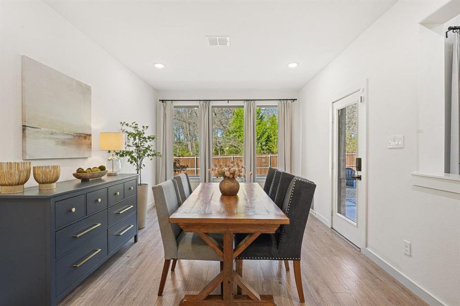 Dining room featuring plenty of natural light, light wood finished floors, and recessed lighting