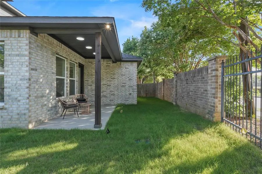 Fenced backyard with a patio